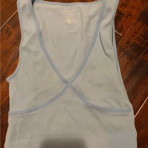 Packs in blue tank top